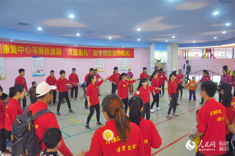 大学生志愿者在康复机构为自闭症儿童示范兔子舞。 吴隆重 摄.jpg